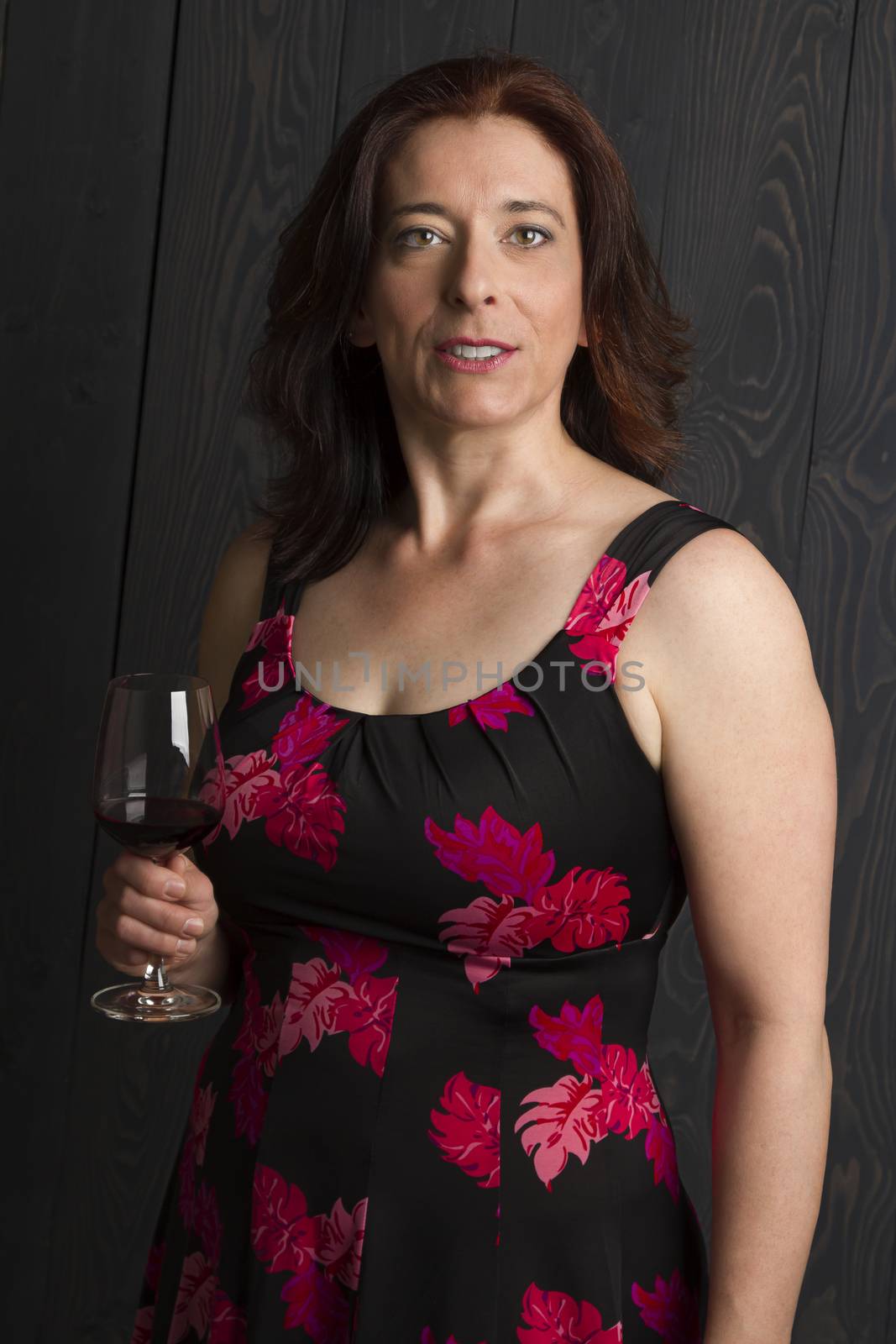 beautiful forty year old woman with a glass of red wine