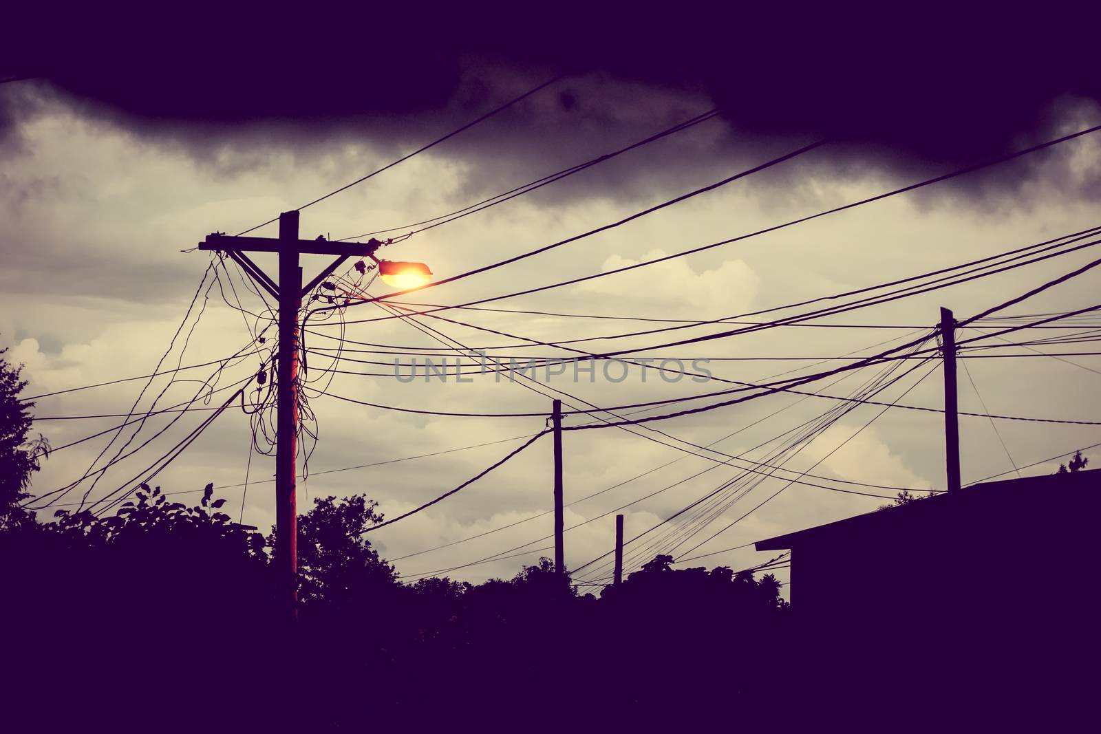 Street light at night with a stormy sky background. Dark mystery scene