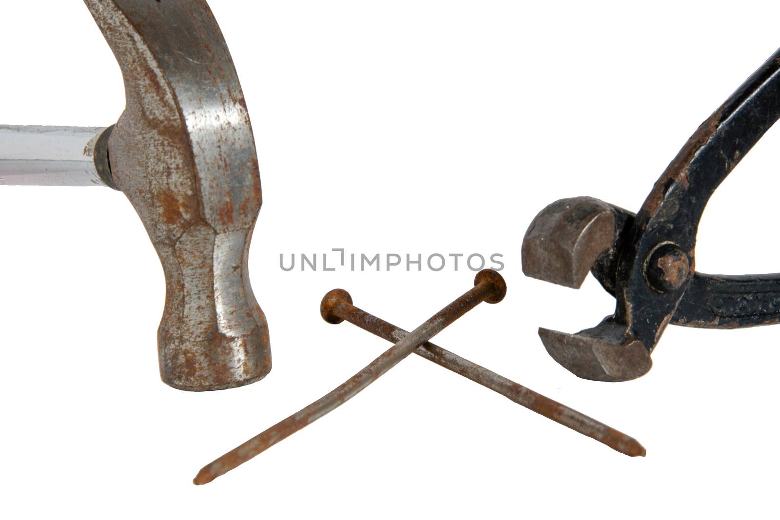 Hammer, tongs and two crossed nails in the middle isolated on white background