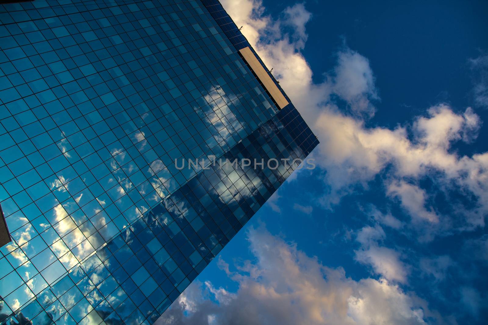 Reflected clouds in the mirror of skyscrapper