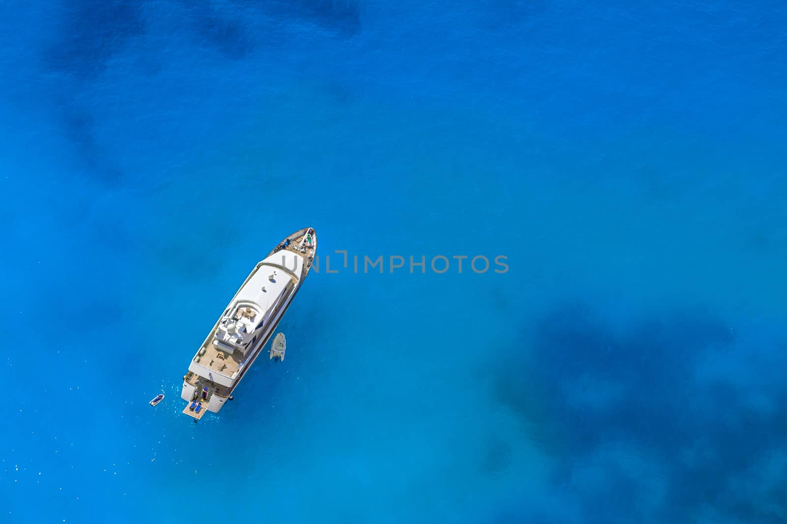 Yacht in the blue sea. View from above by rainfallsup