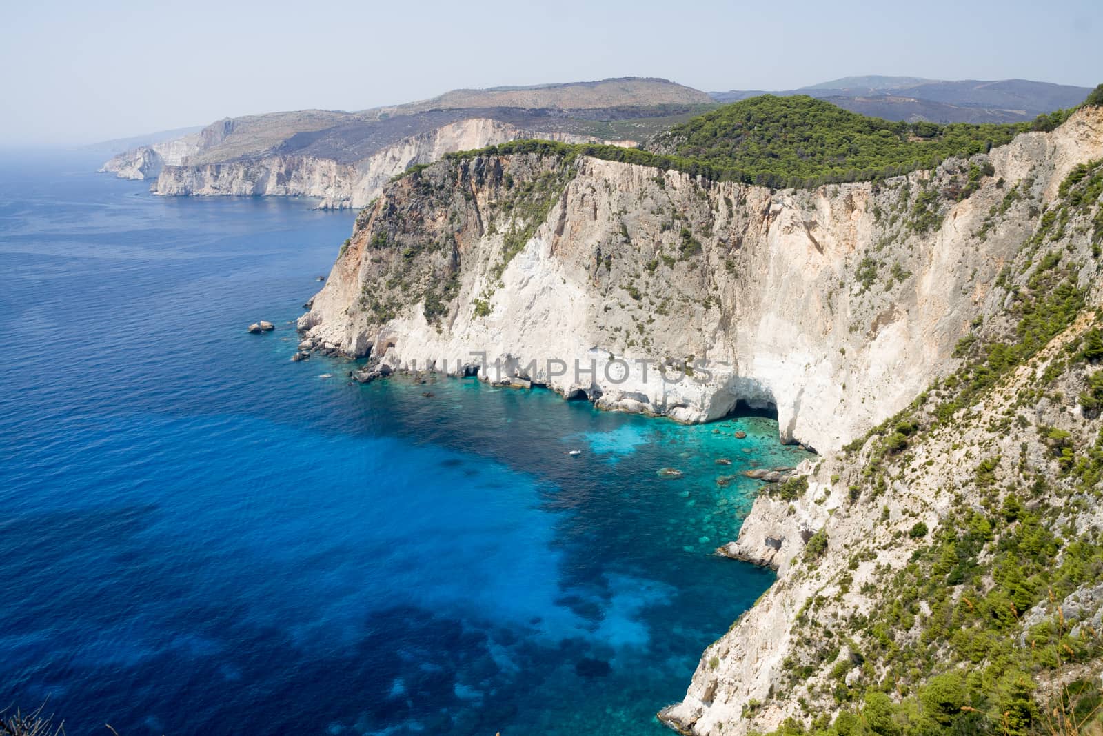 Cliffs of Keri. Zakynthos. Blue sea and rocks by rainfallsup