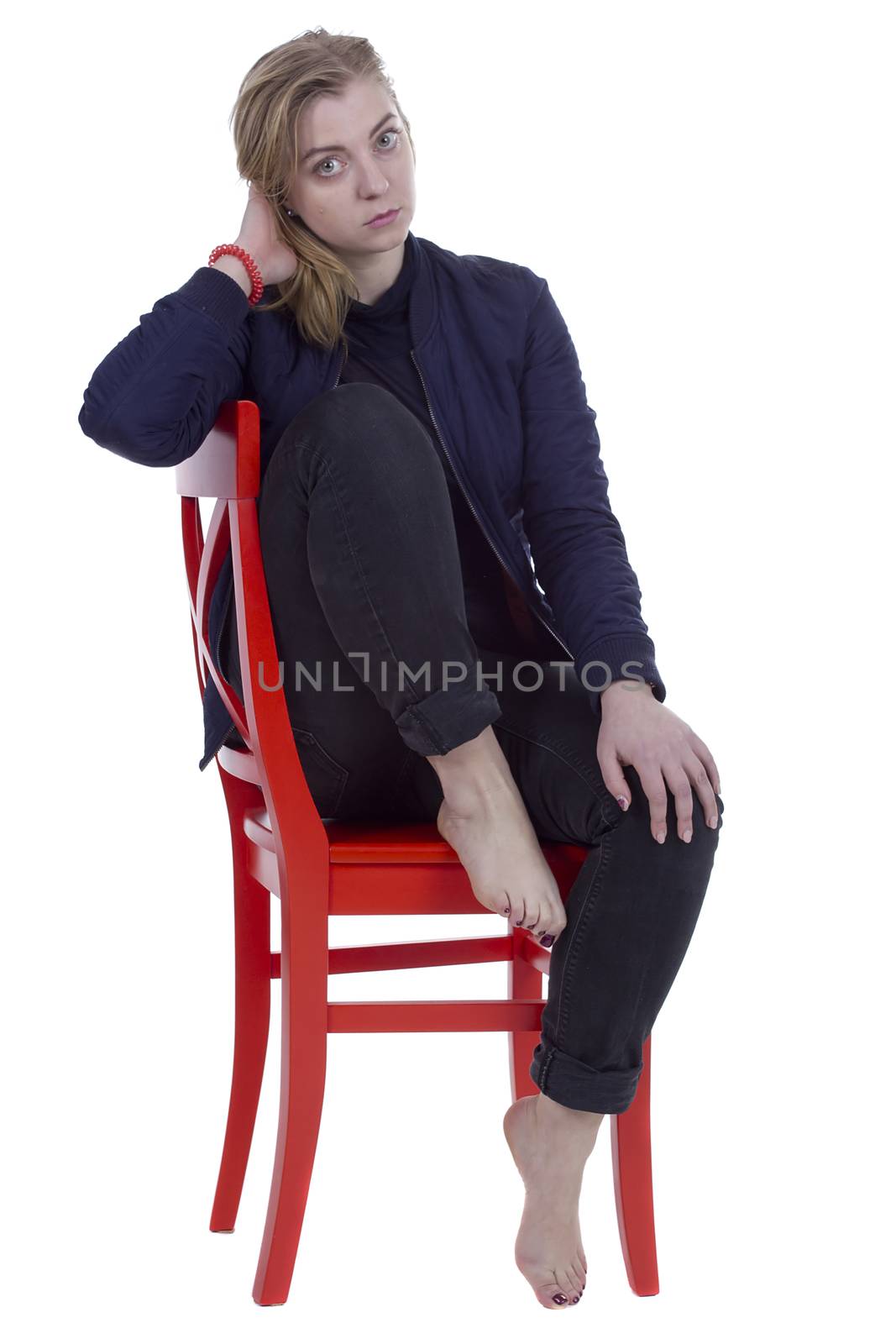 Portrait of a young woman on a red chair