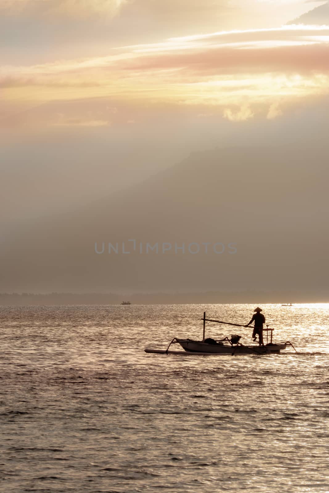 The fisherman boat in the sea in the morning near Rinjani volcano, lombok, indonesia by rainfallsup