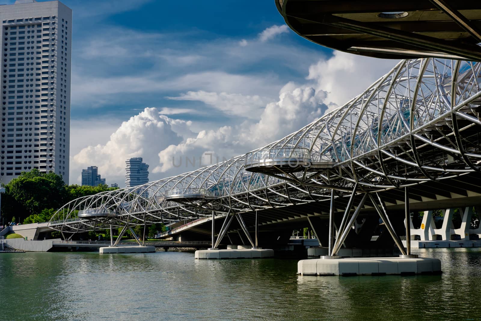Helix Bridge at sunlight with clouds in the background in Singapore