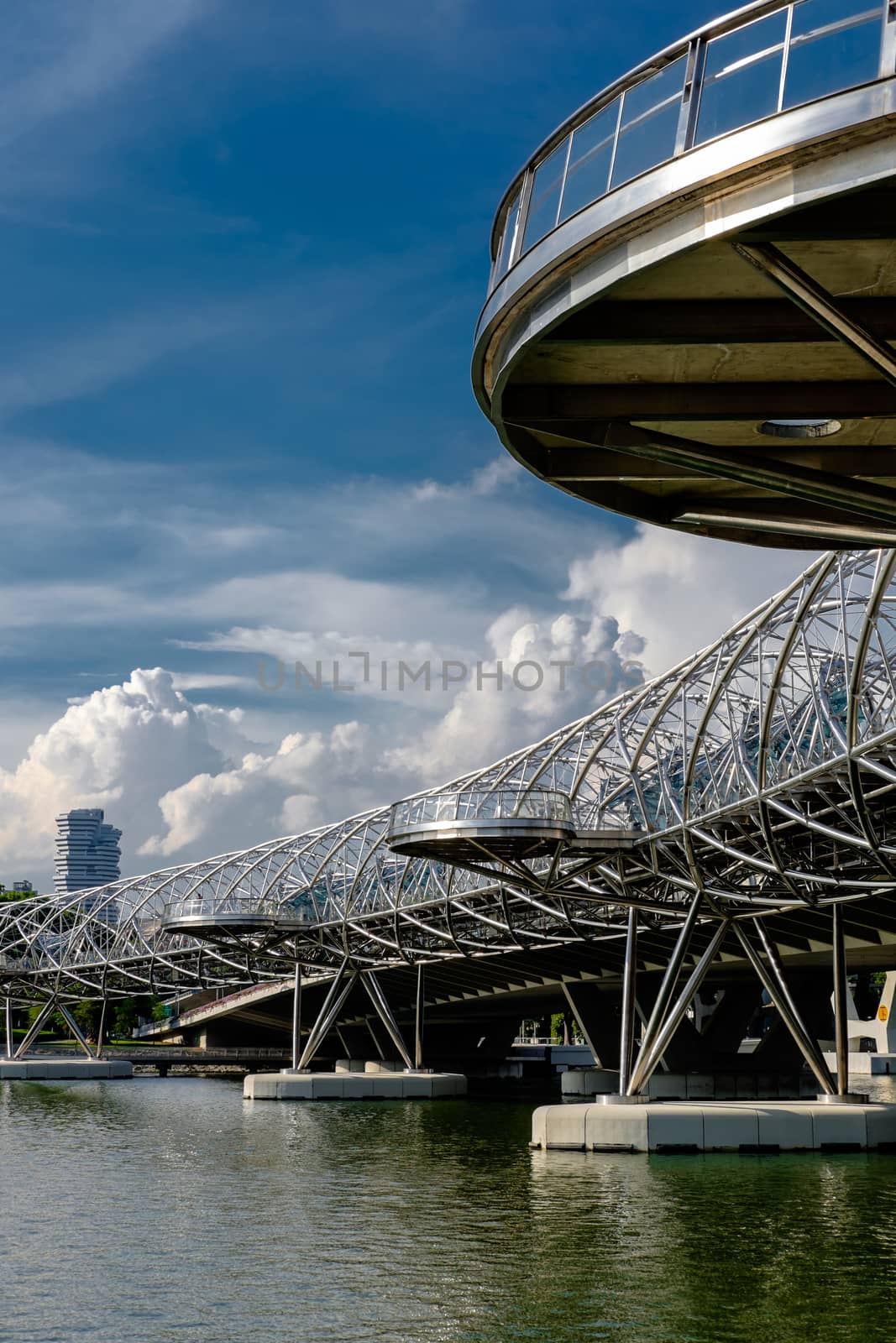 Helix Bridge at sunlight with clouds in the background in Singapore