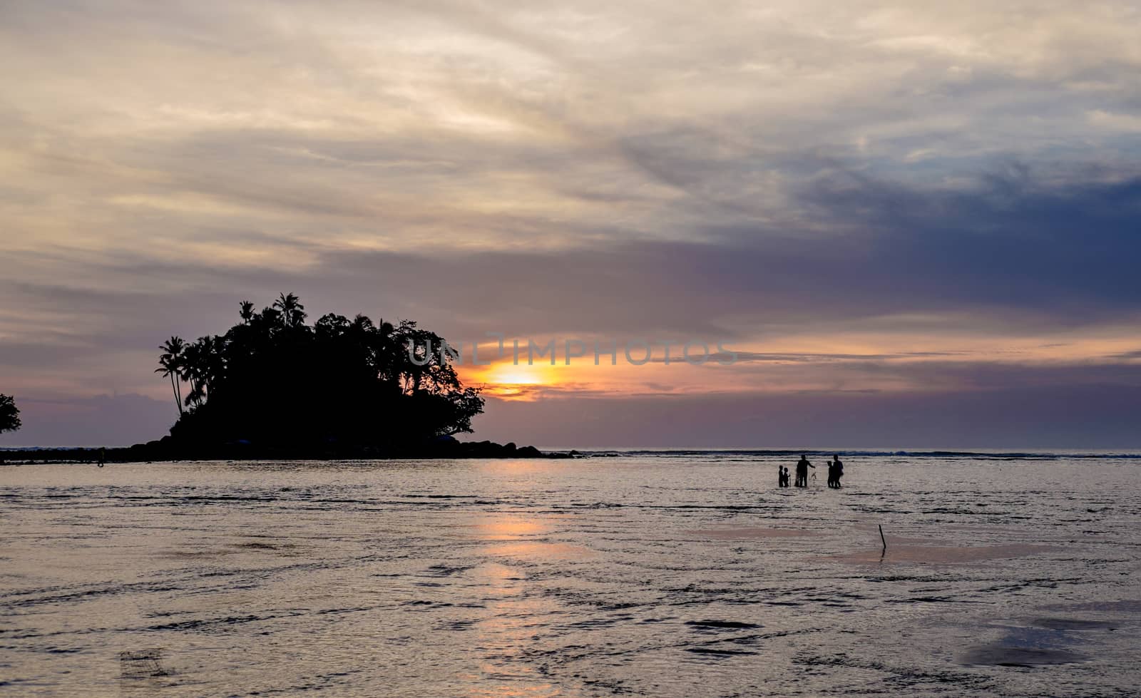 Fisherman with his family is checking nets in the beautiful suns by rainfallsup