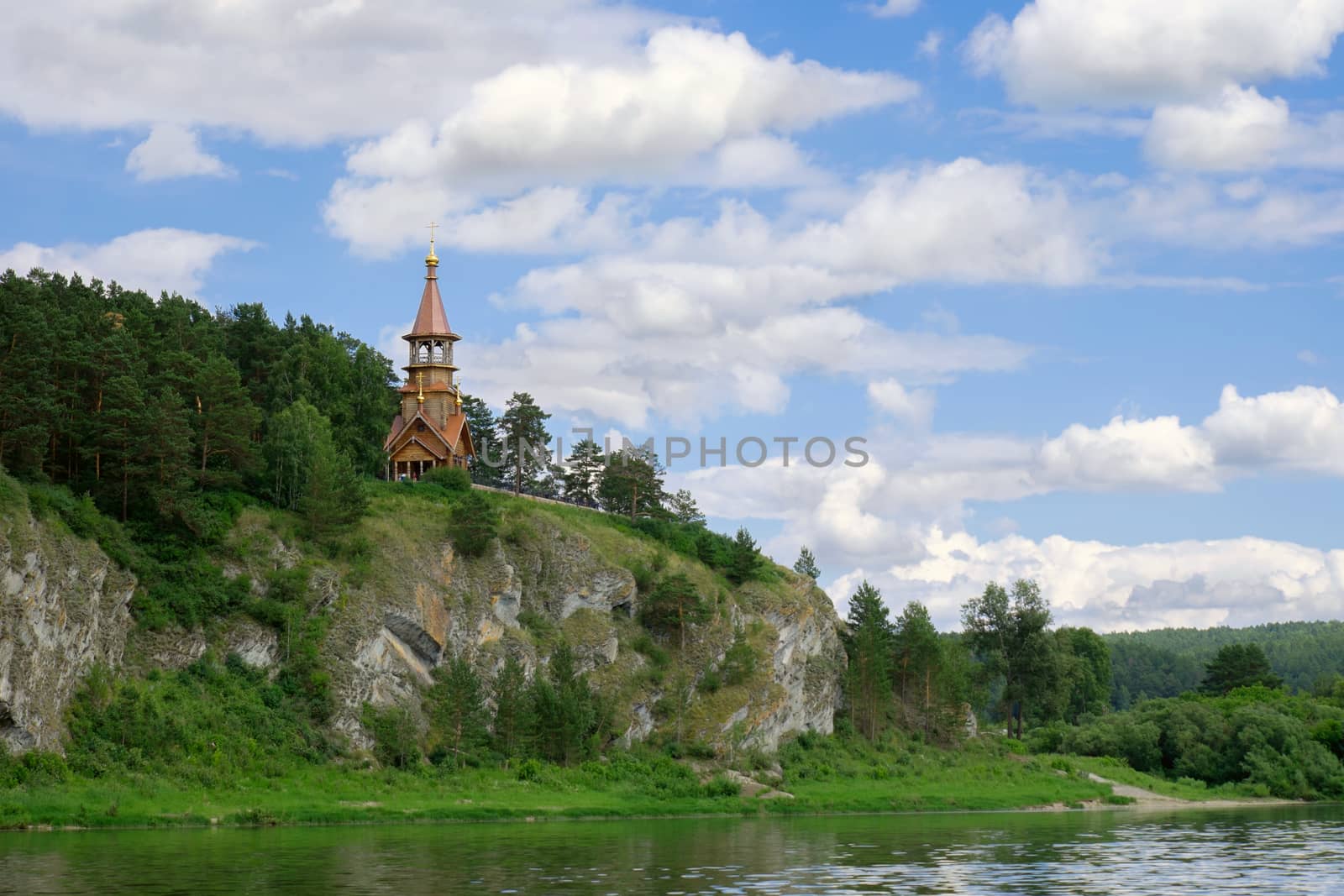 Beautifull wooden christian orthodox church on the bank of the river. Sts Kirill and Methodius chapel at Tomskaya pisanitsa. Siberia. Taiga.