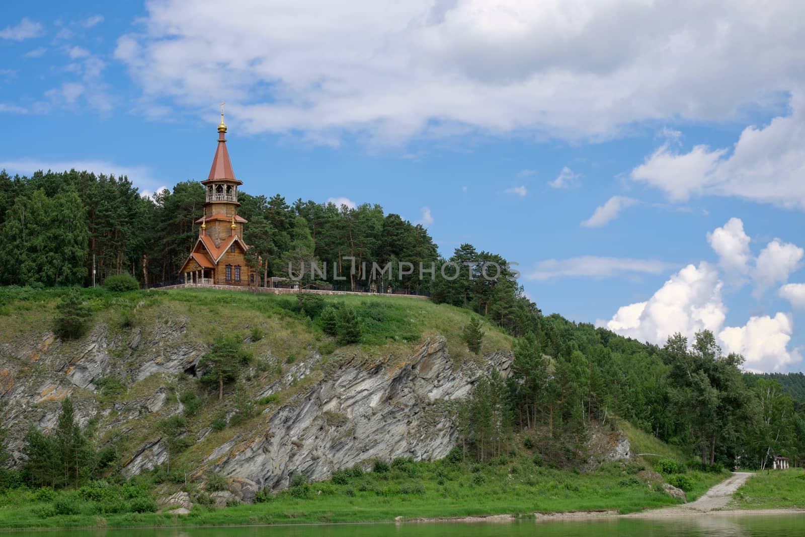 Beautifull wooden christian orthodox church on the bank of the river. Sts Kirill and Methodius chapel at Tomskaya pisanitsa. Siberia. Taiga.