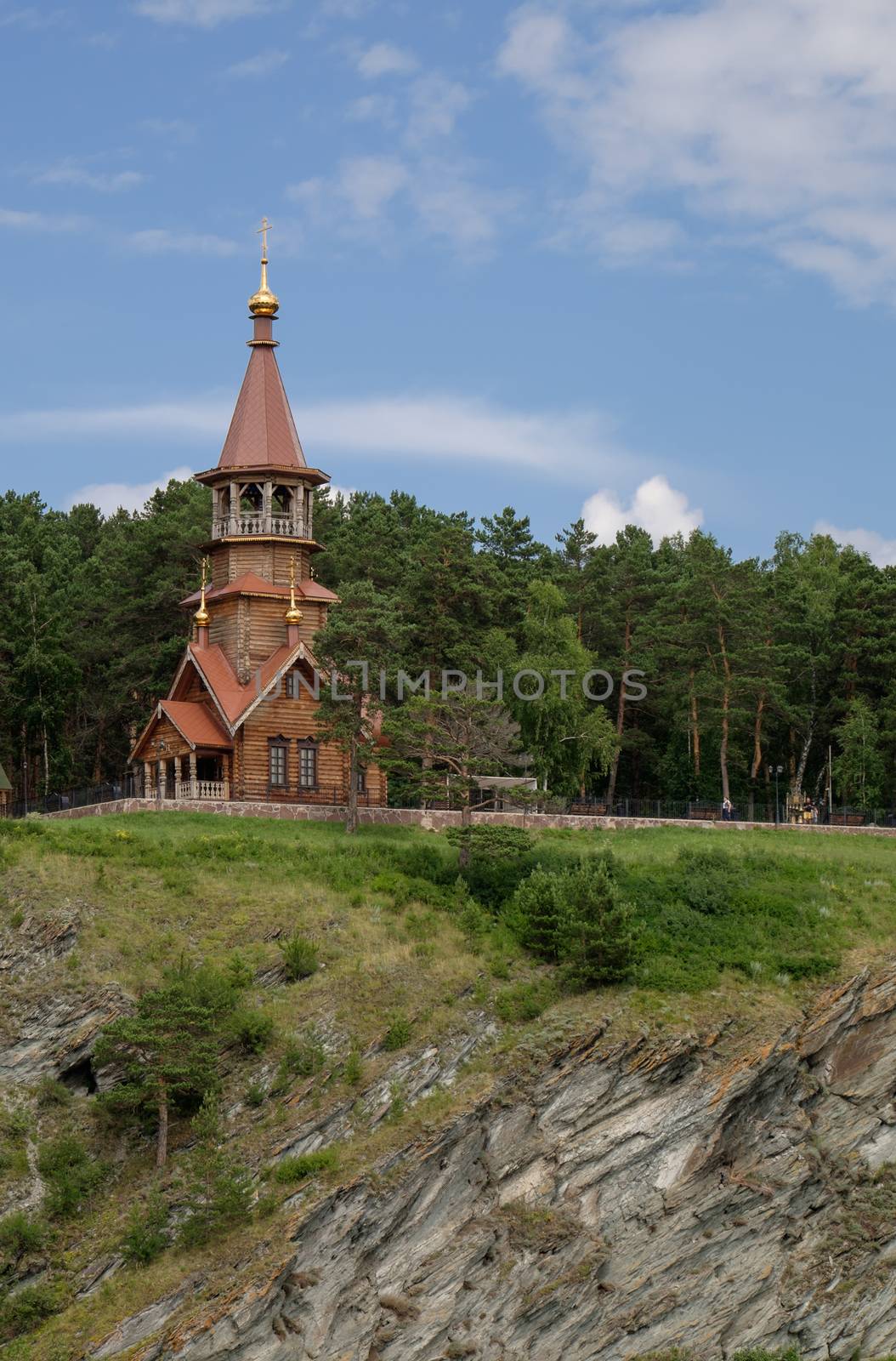 Beautifull wooden christian orthodox church on the bank of the r by rainfallsup