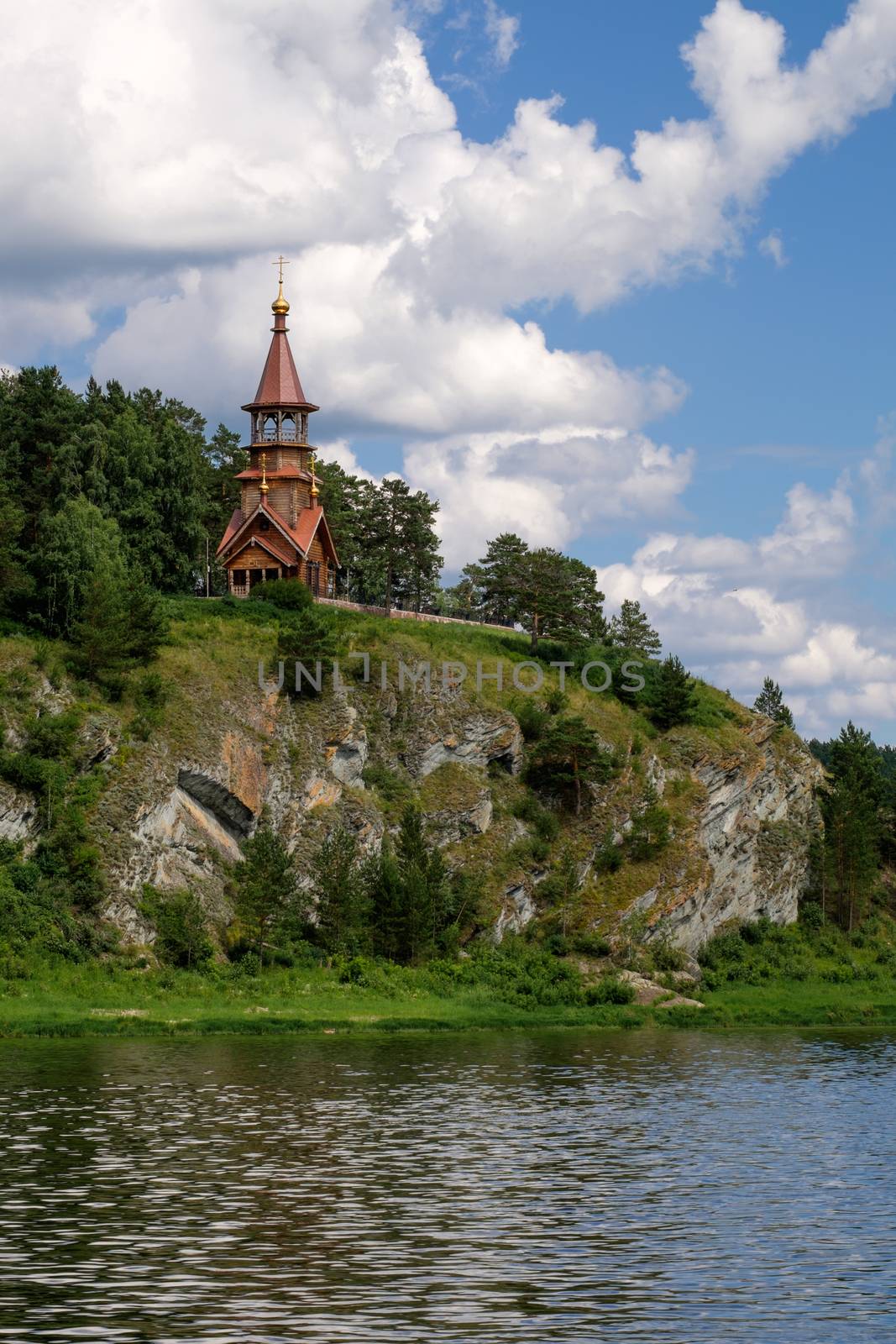 Beautifull wooden christian orthodox church on the bank of the river. Sts Kirill and Methodius chapel at Tomskaya pisanitsa. Siberia. Taiga.