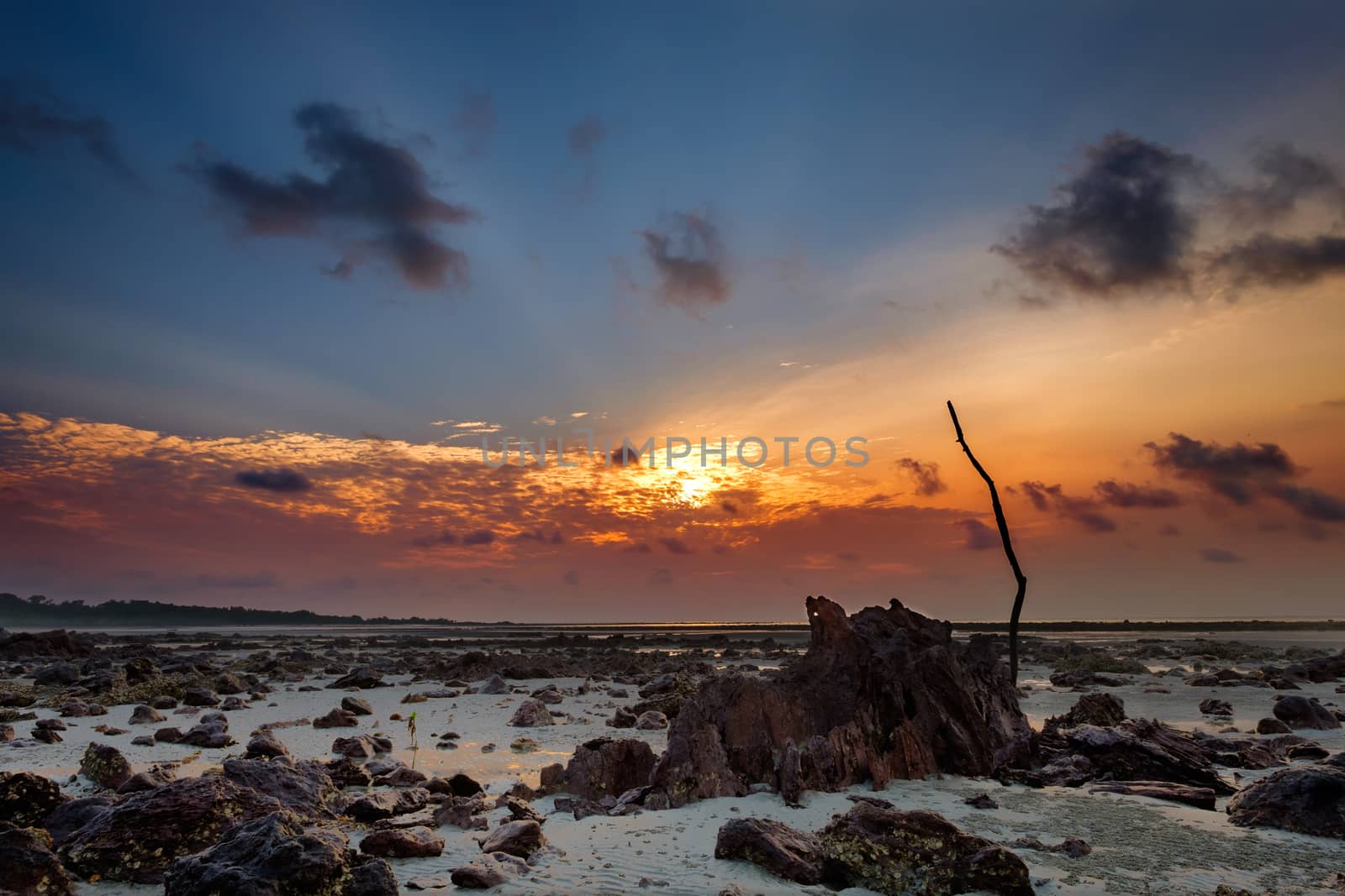 Colourful sunrise and sand  when sea water left during low tide by rainfallsup