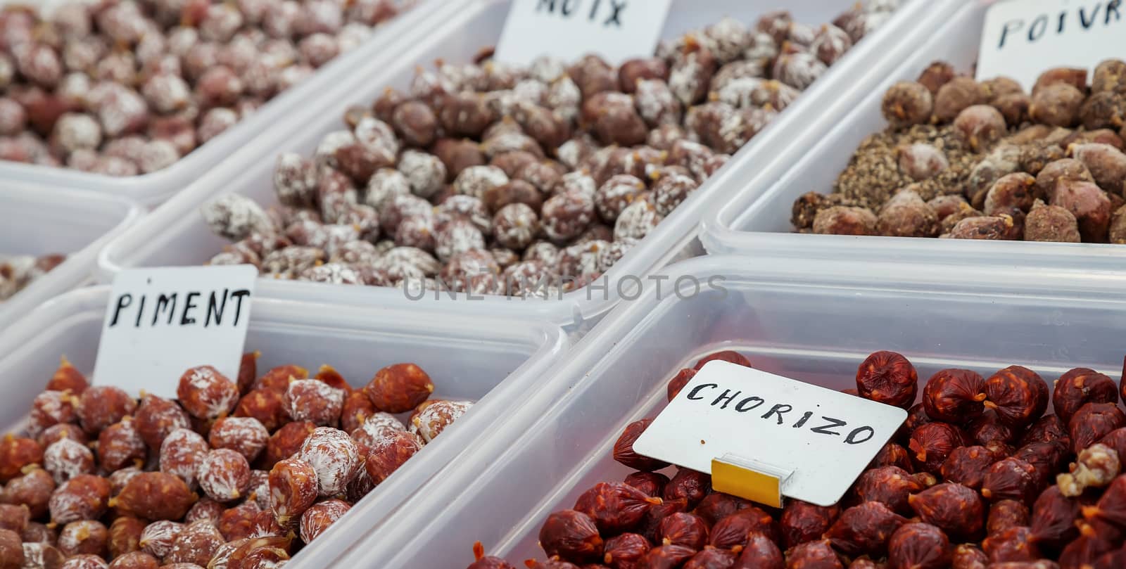 Assortment of chorizo, pepper sausage and nuts sausage on local market. Banner by pixinoo