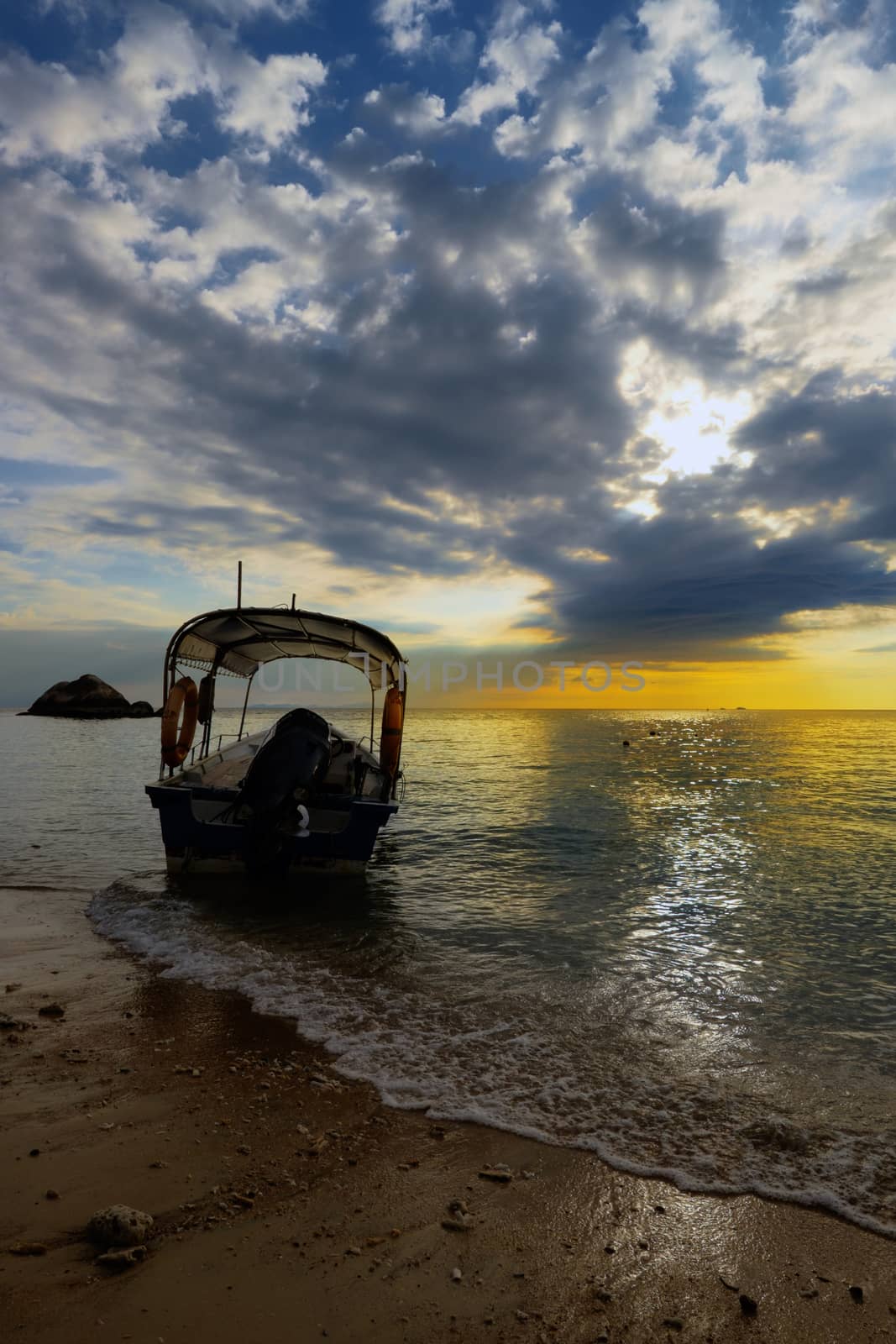 Boat silhouette in the sea at beautiful yellow blue cloudy sunse by rainfallsup