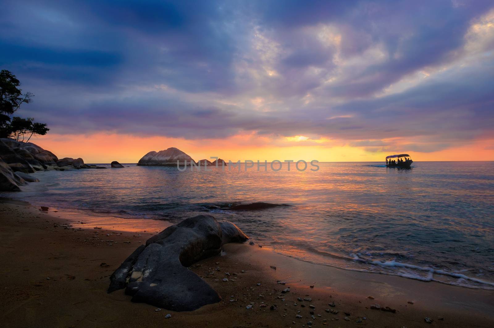 Colorful cloudy sunset at tropical exotic island. Boat, stones,  by rainfallsup