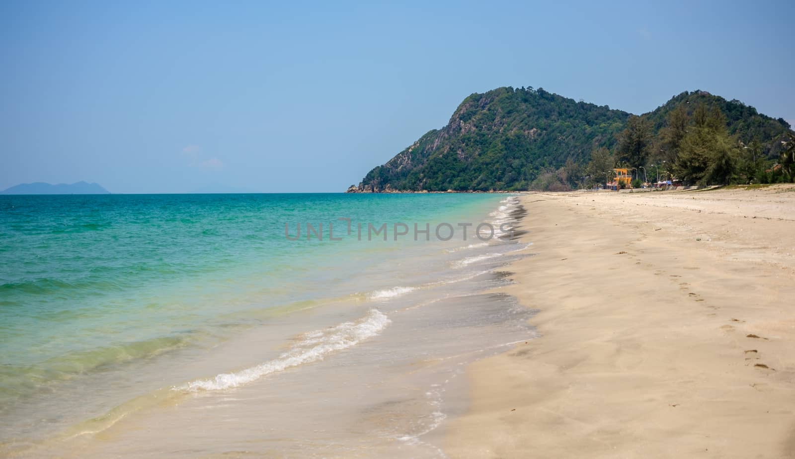 Lonely sandy beach. Green hills, blue sea, white sand. Mersing. Air Papan beach