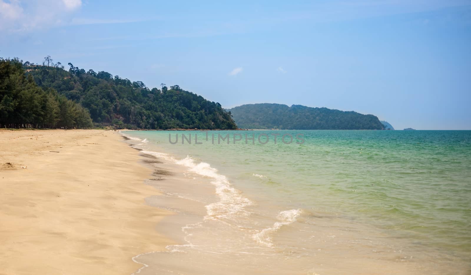 Lonely sandy beach. Green hills, blue sea, white sand. Mersing. Air Papan beach