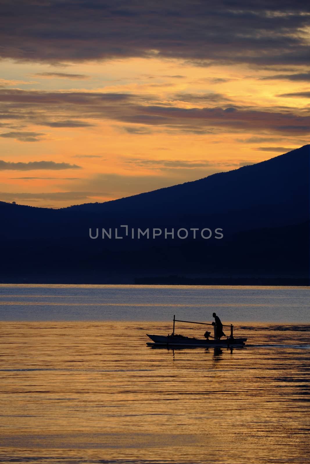 Indonesian fisherman in the morning by rainfallsup