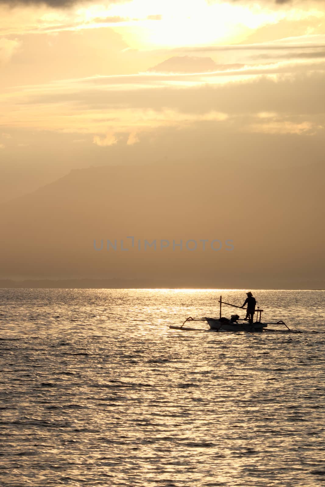 Fisherman in the morning near Rinjani volcano, lombok, indonesia by rainfallsup