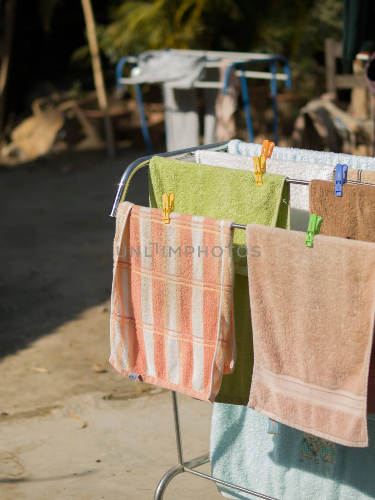 COLOR PHOTO OF GROUP OF TOWELS UNDER SUNLIGHT