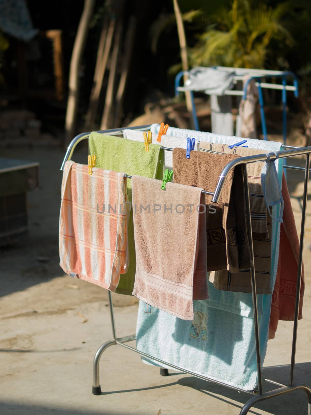 COLOR PHOTO OF GROUP OF TOWELS UNDER SUNLIGHT