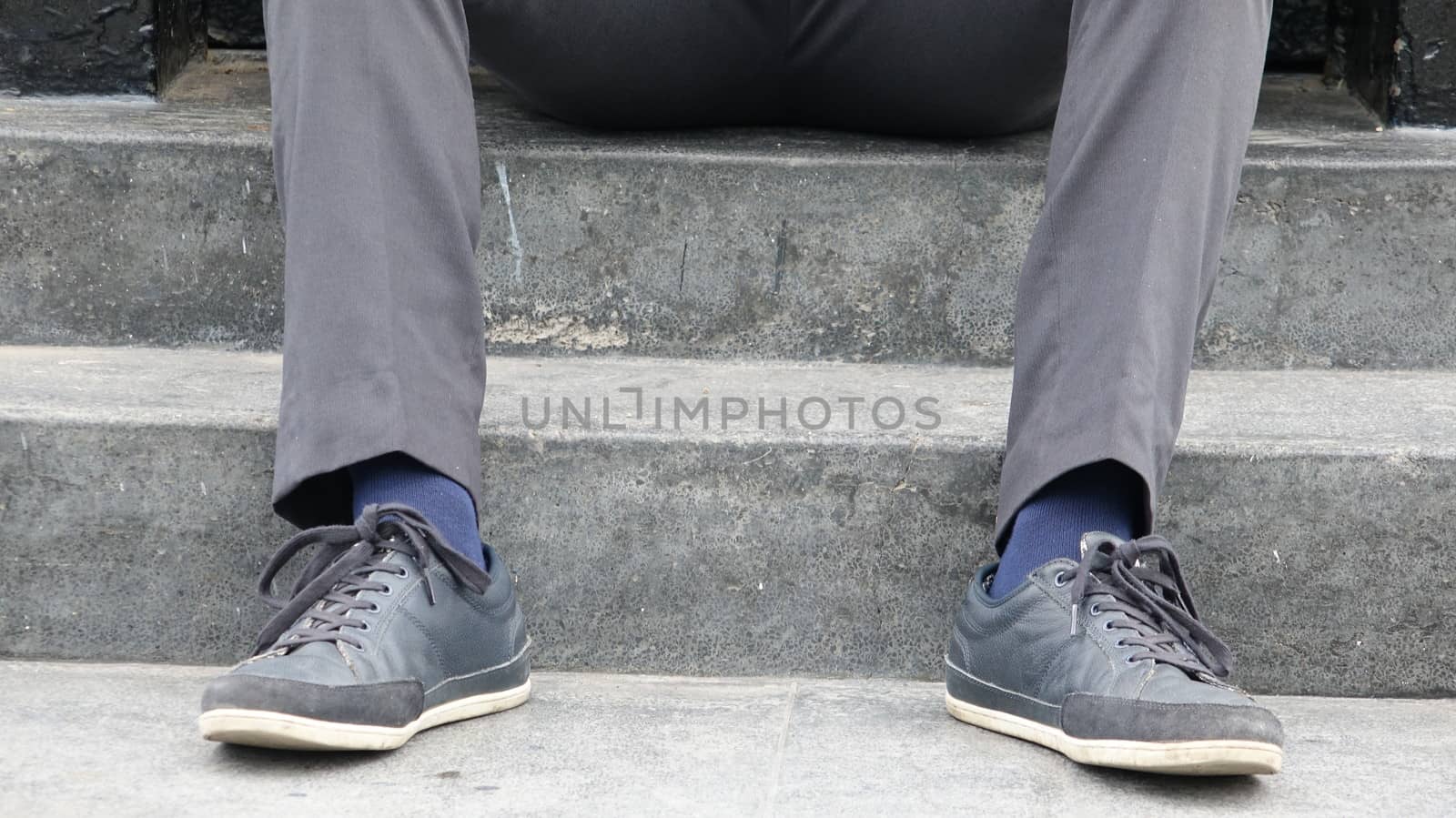 Shoes And Feet Of Man Sitting On Steps