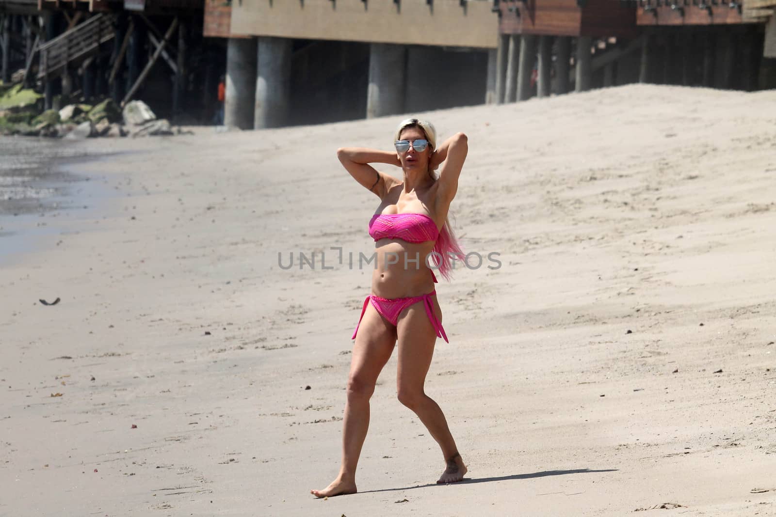 Frenchy Morgan the "Celebrity Big Brother" Star is spotted doing yoga and karate on the beach while wearing a tiny pink bikini, Malibu, CA 04-21-17/ImageCollect by ImageCollect