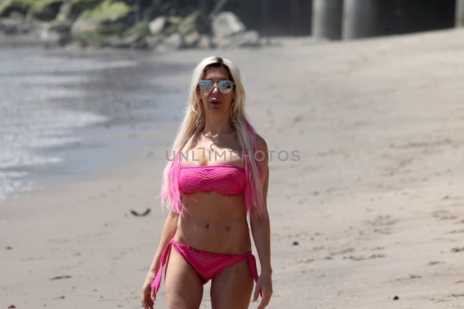 Frenchy Morgan the "Celebrity Big Brother" Star is spotted doing yoga and karate on the beach while wearing a tiny pink bikini, Malibu, CA 04-21-17