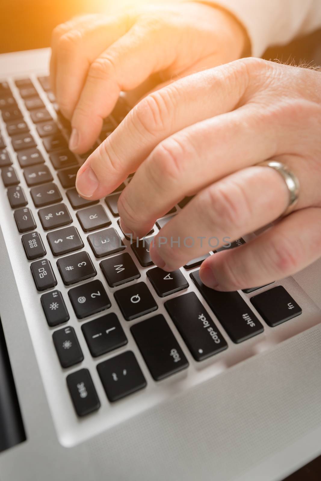 Male Hands Typing on Laptop Computer Keyboard.