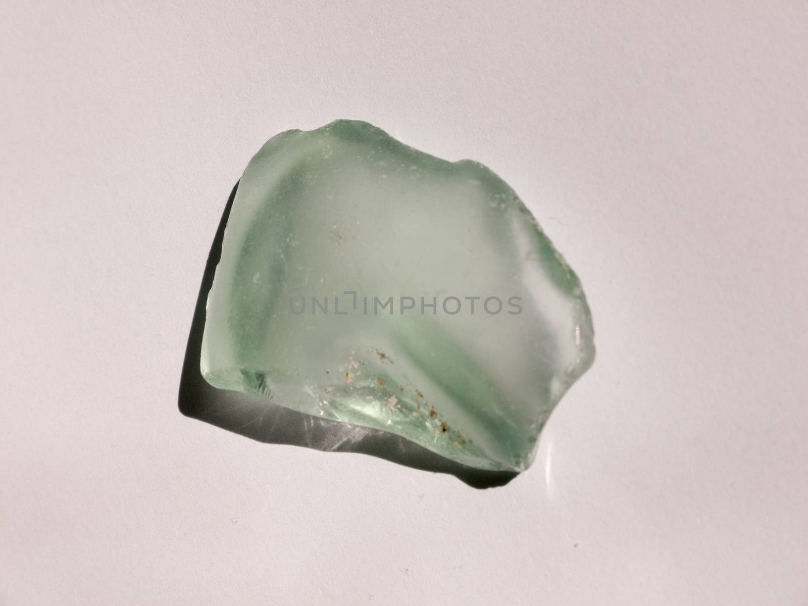 A clear crystal glass rock found on a beach