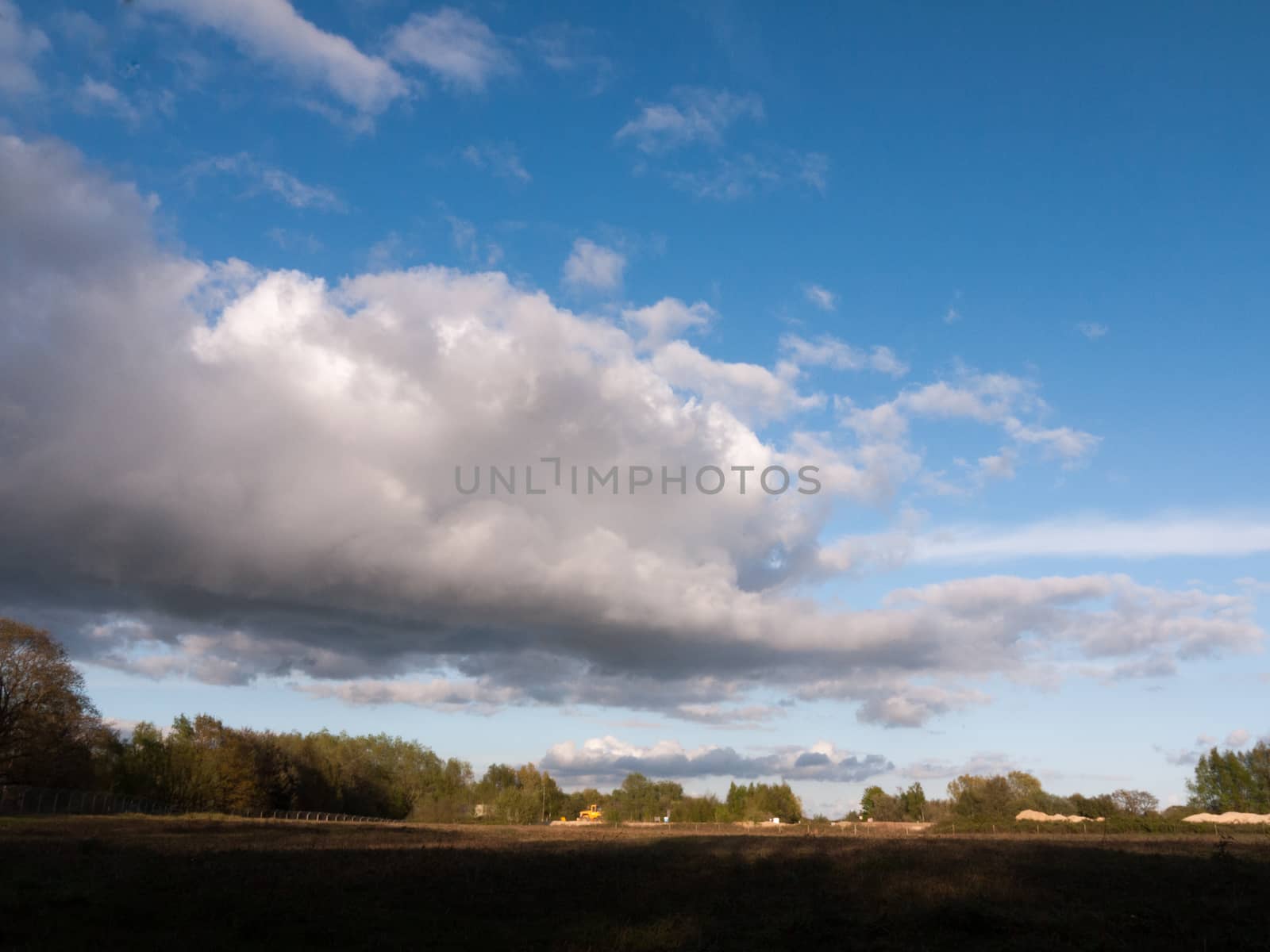 a big rolling cloud of white over a landscape shot of farmland w by callumrc