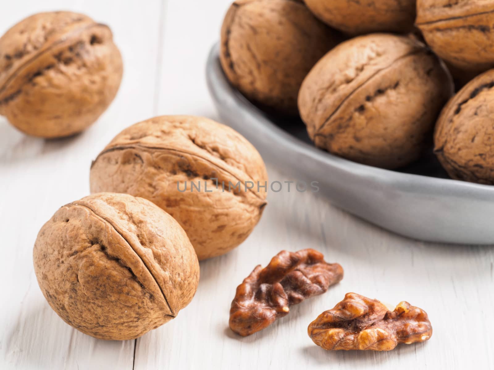 inshell walnut on white wooden background by fascinadora