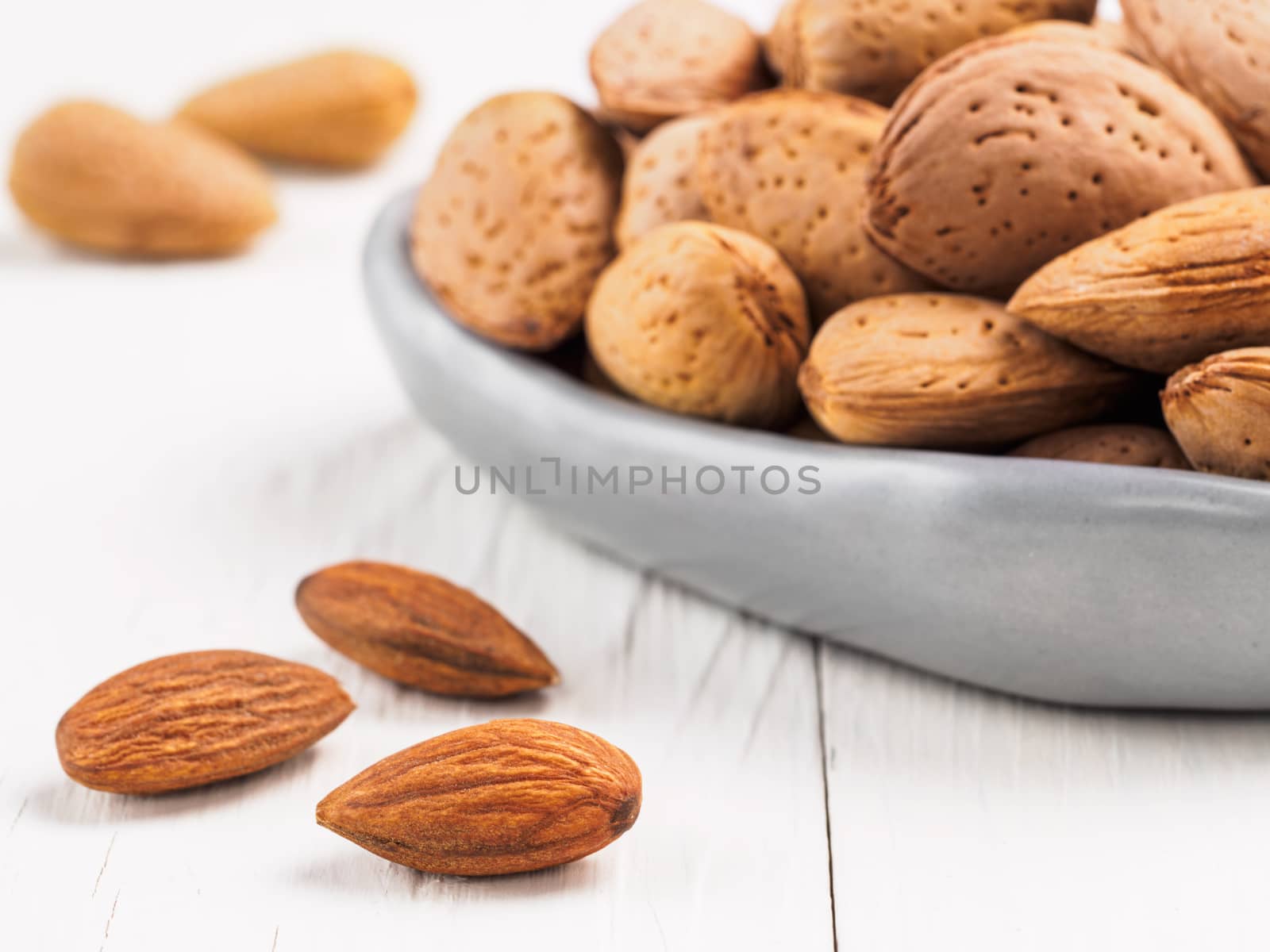 Almond on white wooden background by fascinadora
