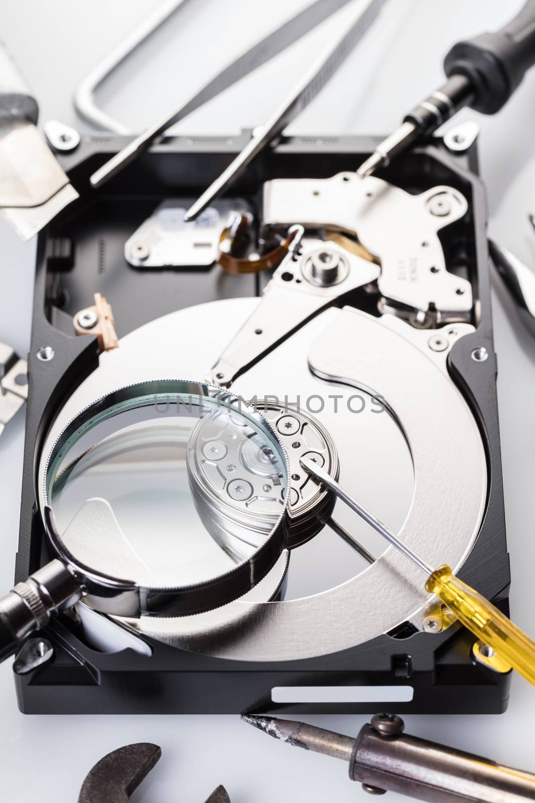 Disassembled computer hard disk and tools close-up