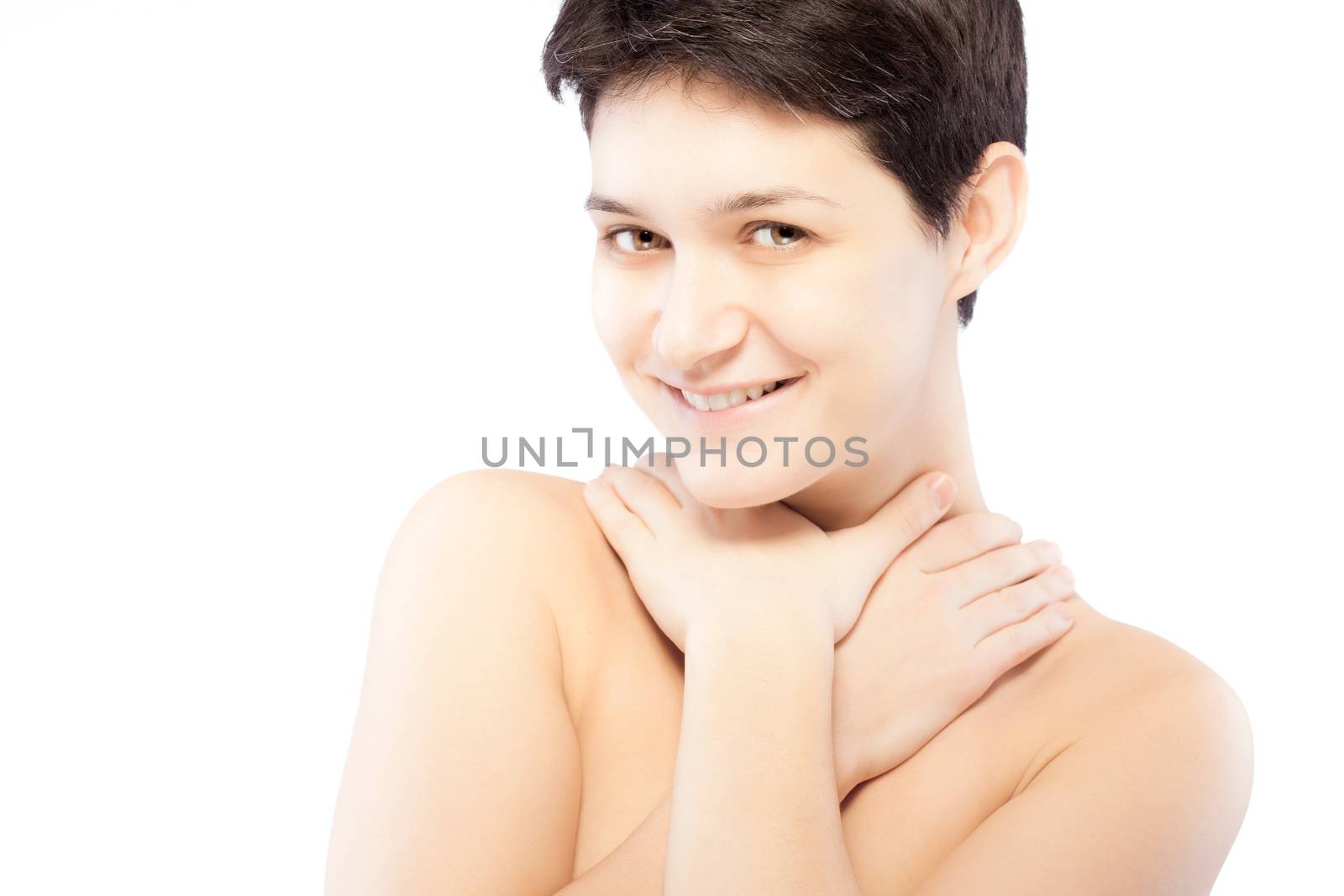 girl with a short hair touching her neck, smiling and looking at camera