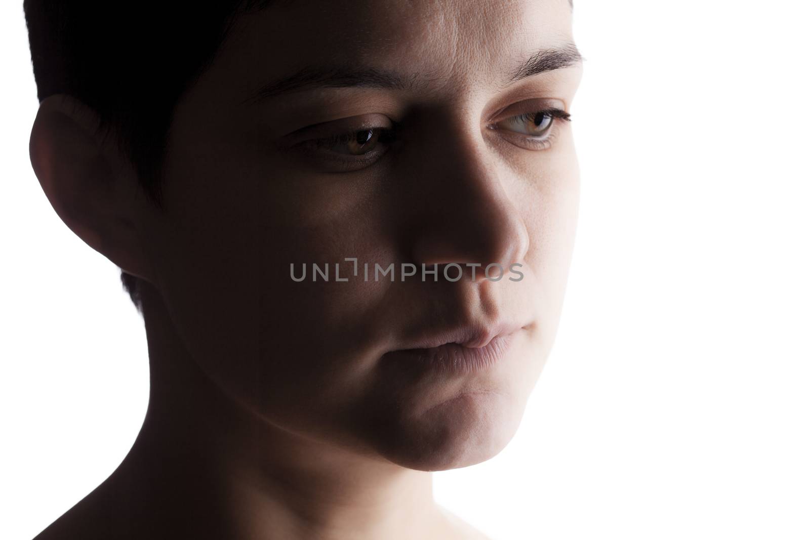 portrait of a girl with a short hair looking at camera, making serious expression