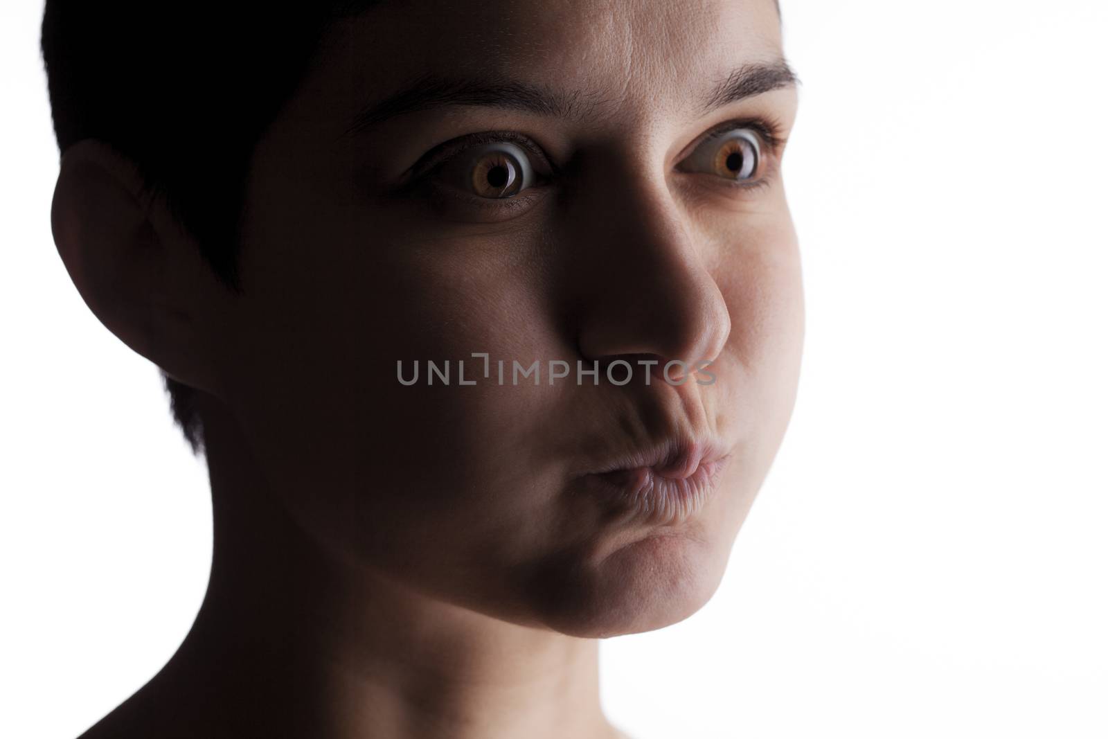 portrait of a girl with a short hair looking at camera, making strange expression