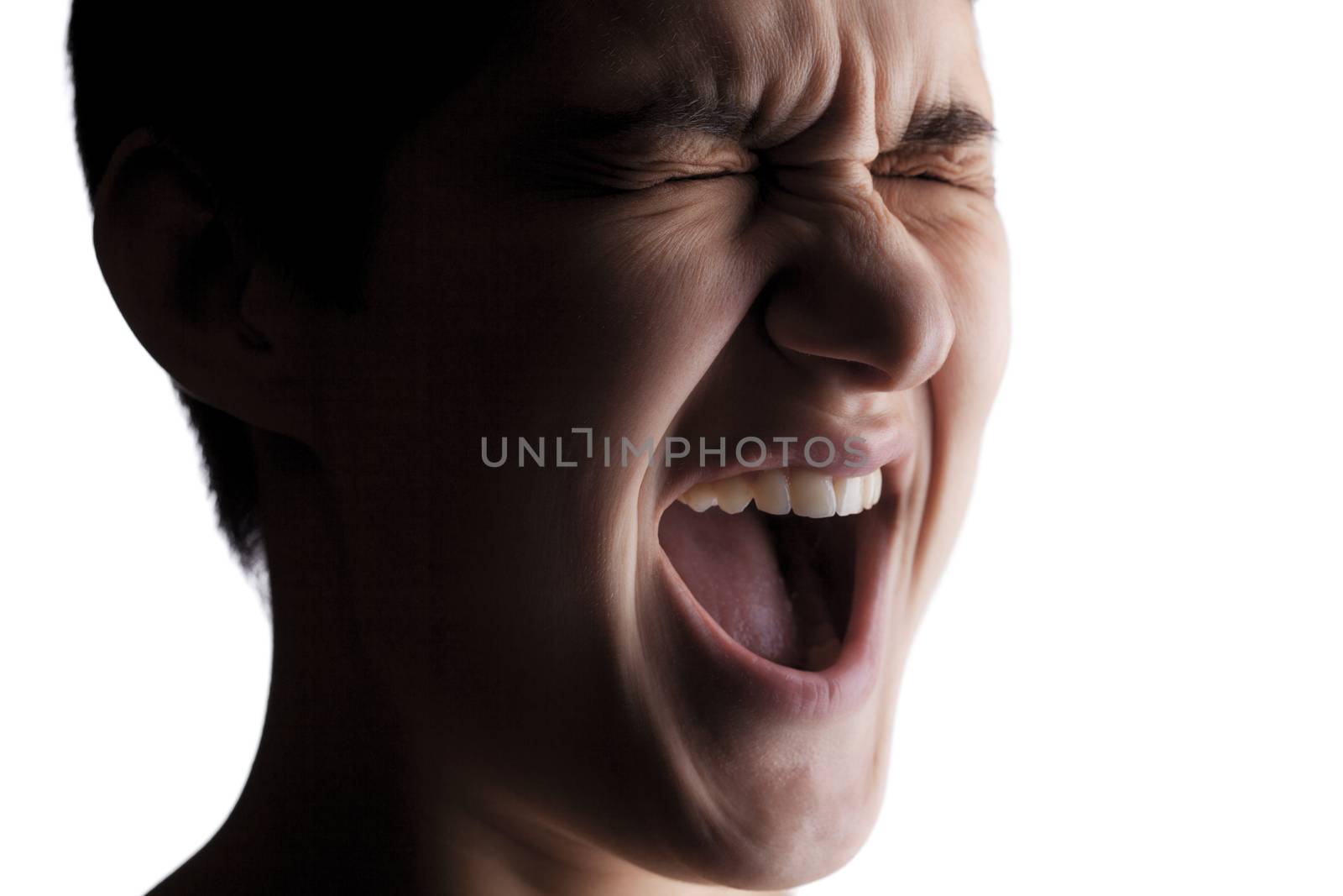 portrait of a girl with a short hair looking at camera, screaming, in pain expression