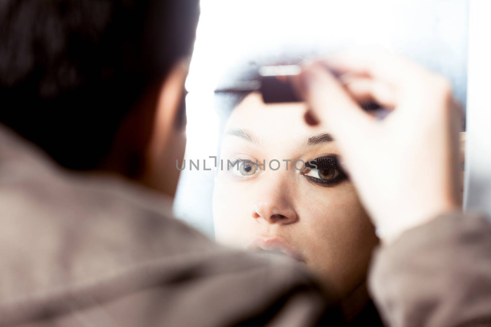 girl with a short hair putting some make up