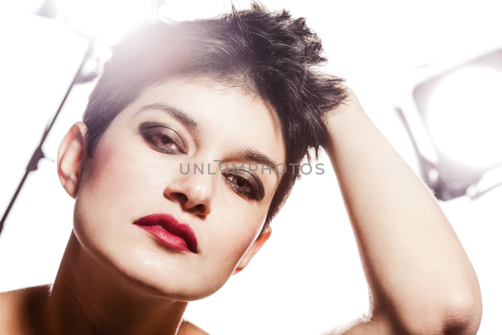 studio portrait of a girl with short hair, looking at camera