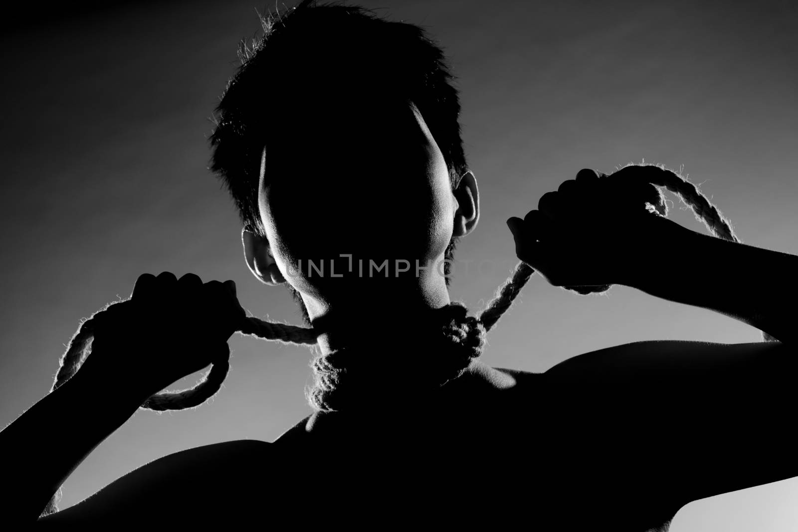 silhouette portrait of a girl with short hair, having rope around her neck