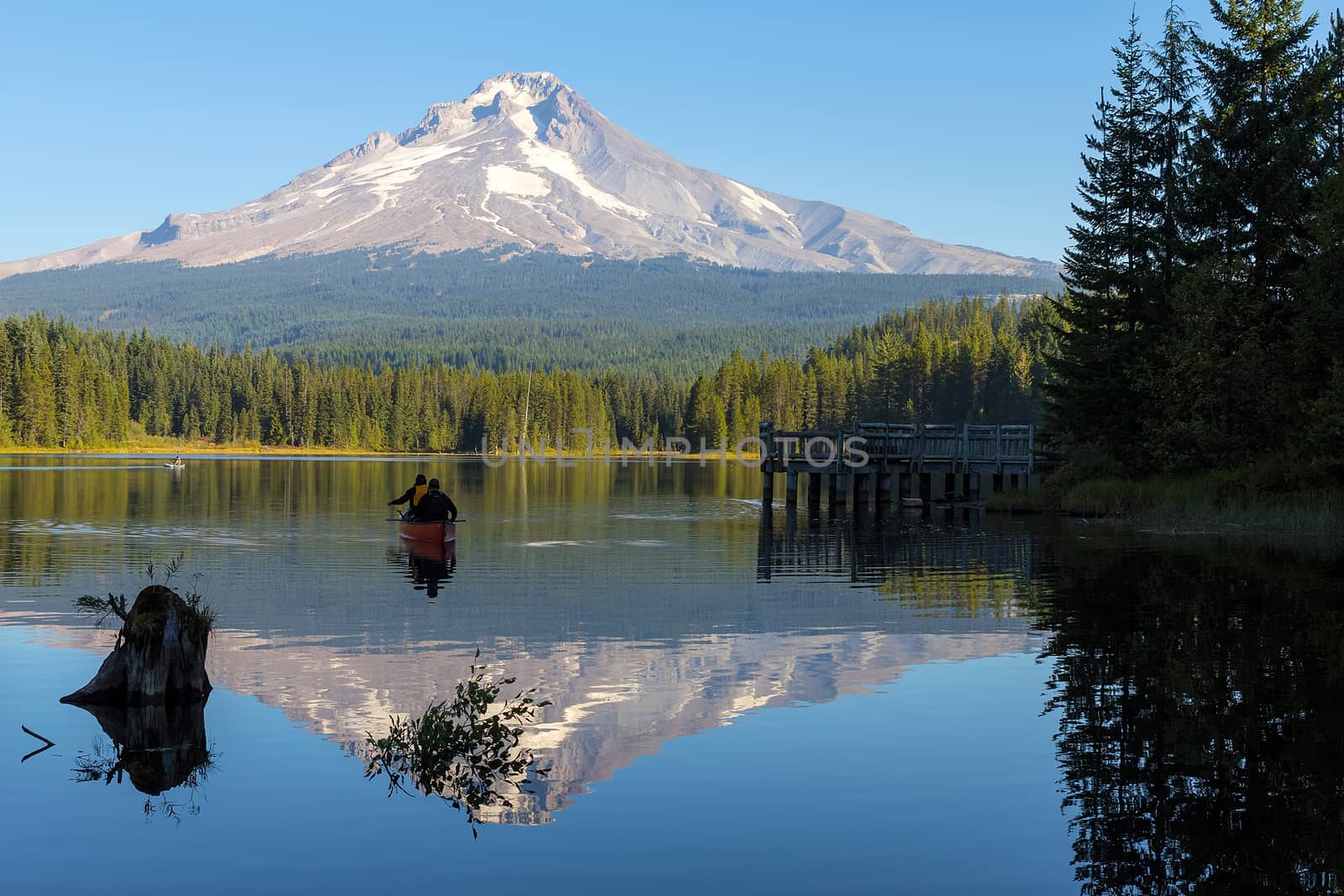 Canoeing and Fishing at Trillium Lake in Oregon with Mount Hood view on a blue sky sunny day