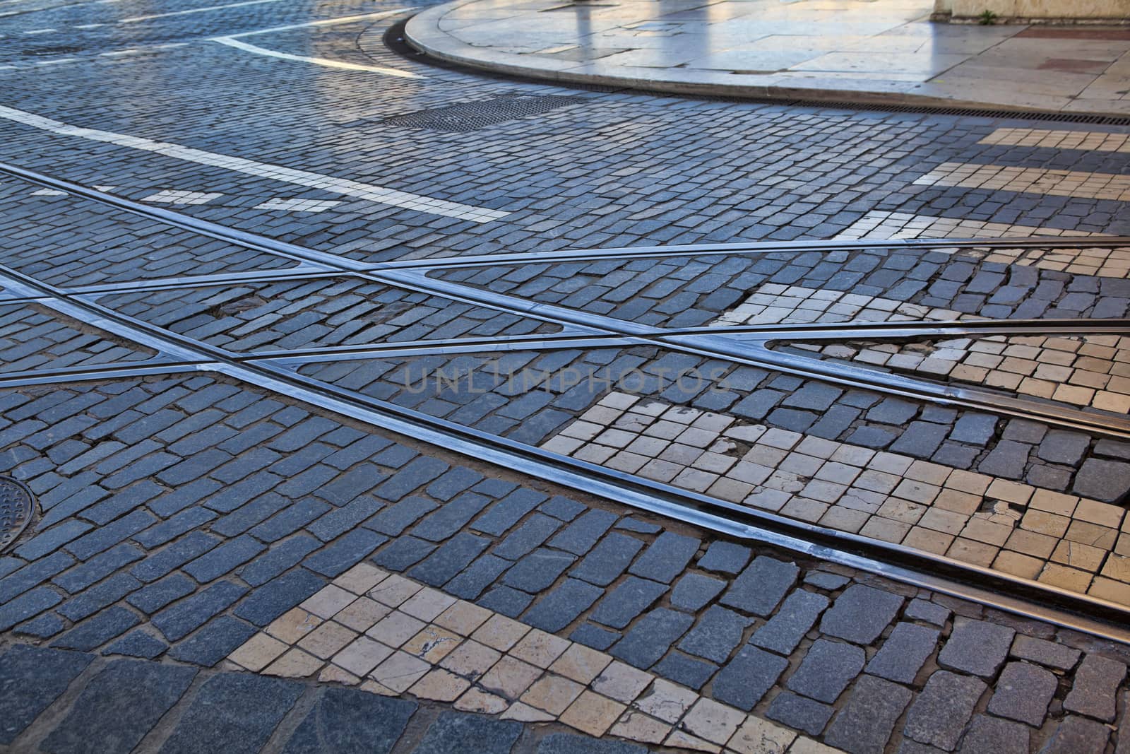 Old rail lines on cobbled road surface