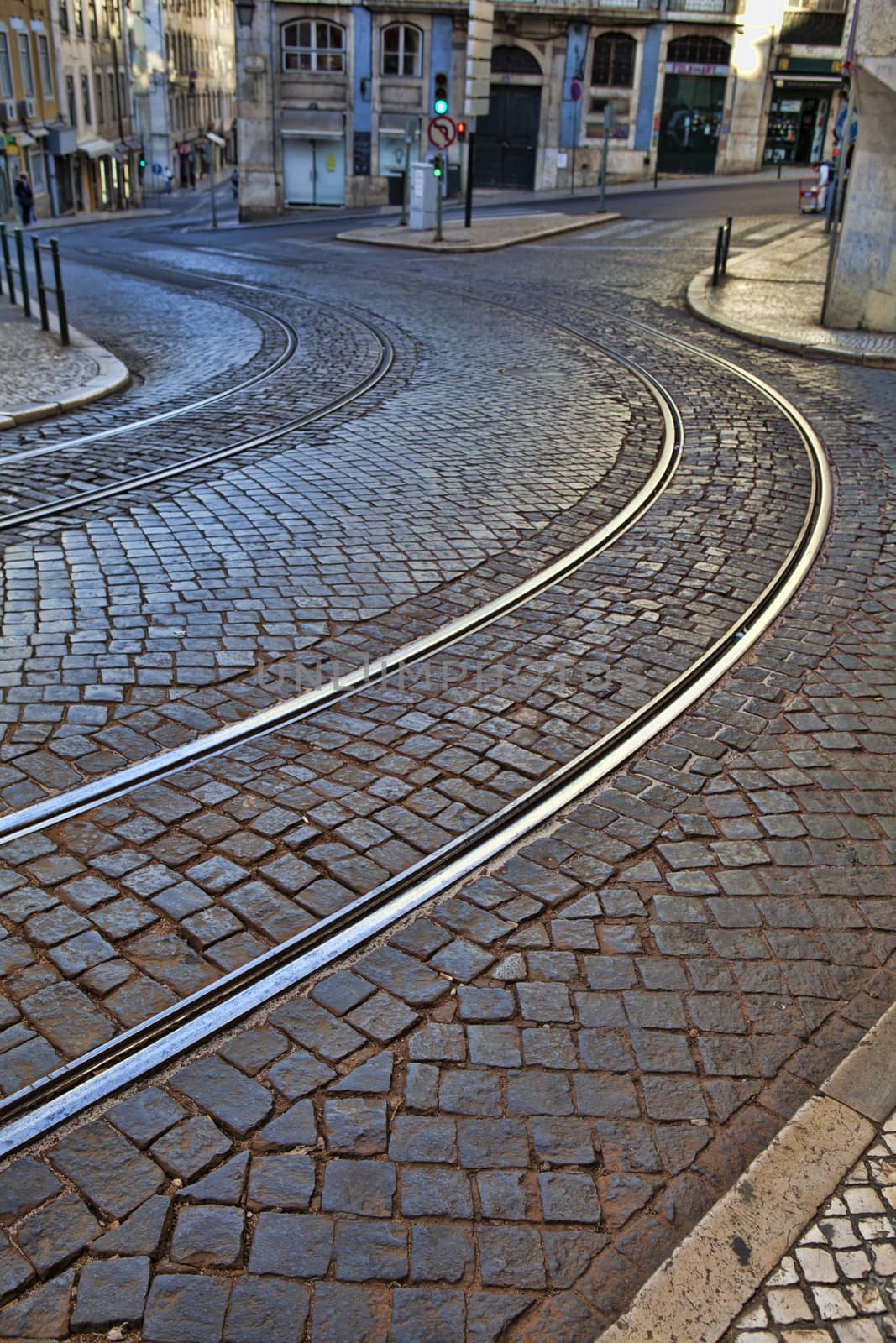 Old rail lines on cobbled road surface by kalnenko