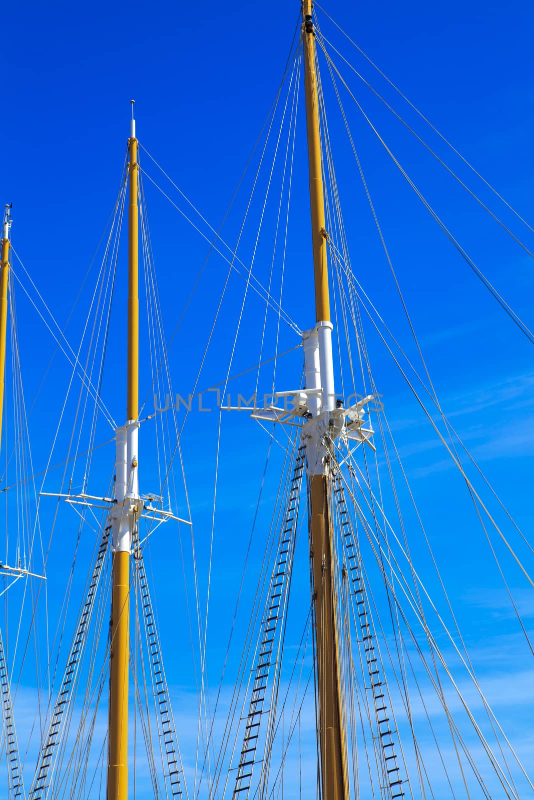 Yacht mast against blue summer sky