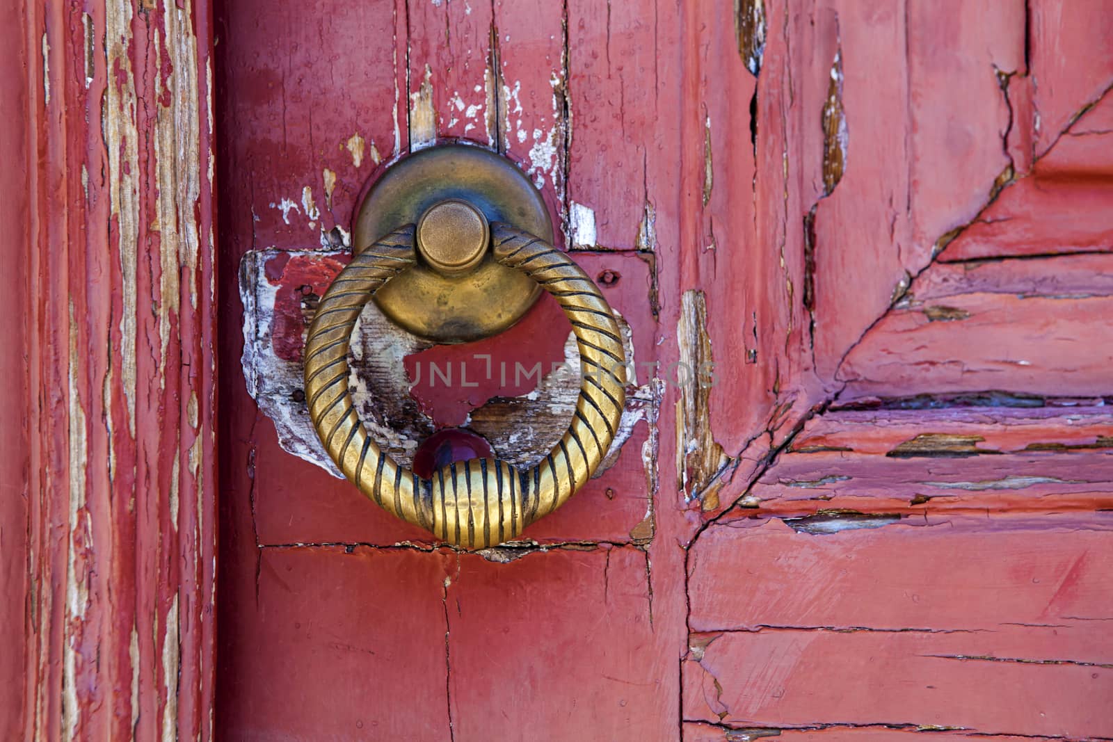 Brass  knocker on old wooden door in Lisbon