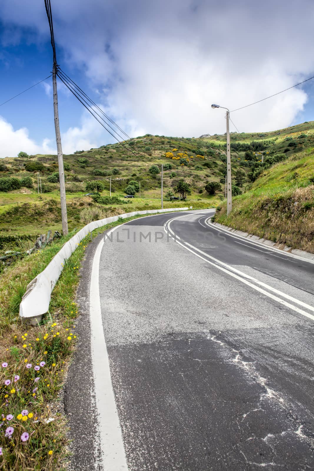 Asphalt road . Clouds on blue sky in summer day 