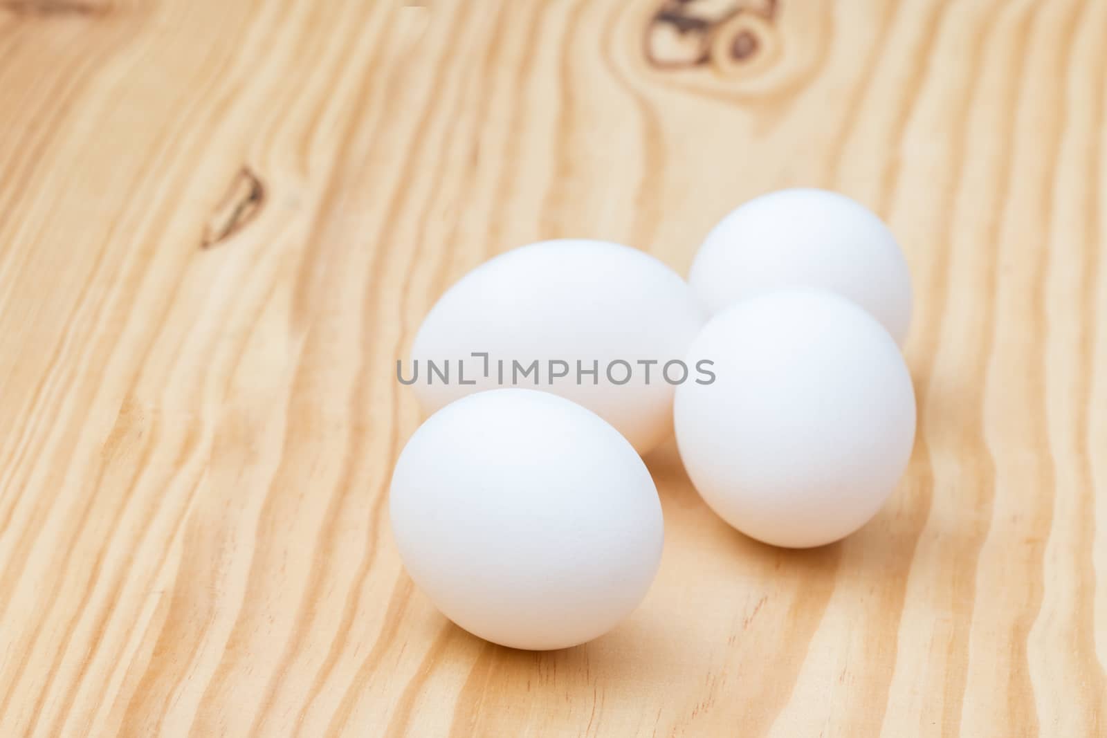 Eggs on wooden background.