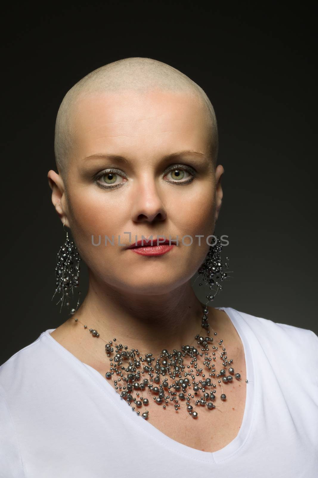Portrait of beautiful middle age woman sad patient with cancer with shaved head without hair, hope in healing. She lost her hair