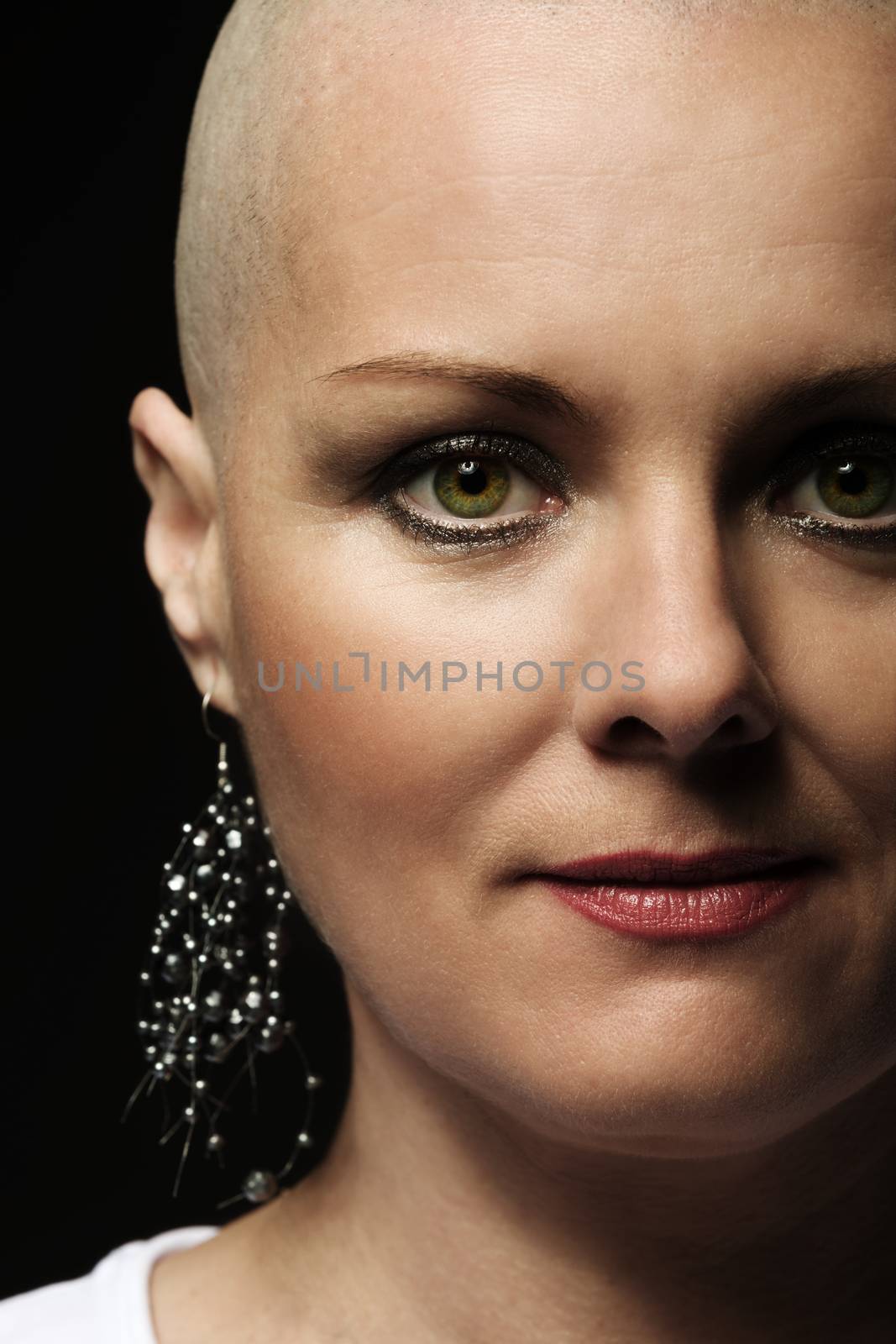 Portrait of beautiful middle age woman patient with cancer with shaved head without hair, hope in healing. She lost her hair
